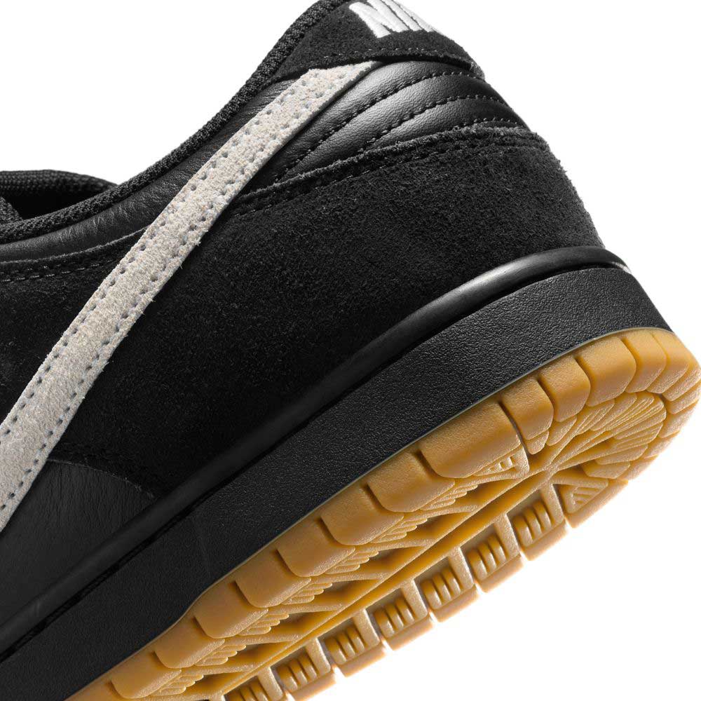 Close-up of the heel and side of the HF3704003 Black White Nike SB Dunk Low Pro Suede Leather Shoes, showing the black suede, white stripe, and gum-colored sole. The visible textures highlight its stylish and durable finish.