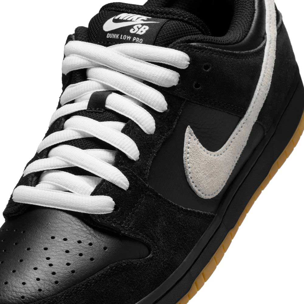 Close-up of the HF3704003 Black White Nike SB Dunk Low Pro Suede Leather Shoes featuring black suede leather, white laces, a white Nike Swoosh, brown gum rubber sole, and a tongue with white Nike SB branding.
