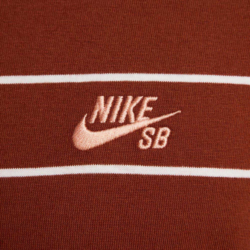 Close-up of the HJ0812619 U NK SB TEE M90 Maroon Red STRIPE, featuring brown fabric with two white stripes and a light pink embroidered Nike SB Skateboarding logo—ideal for any SB Tee collection.