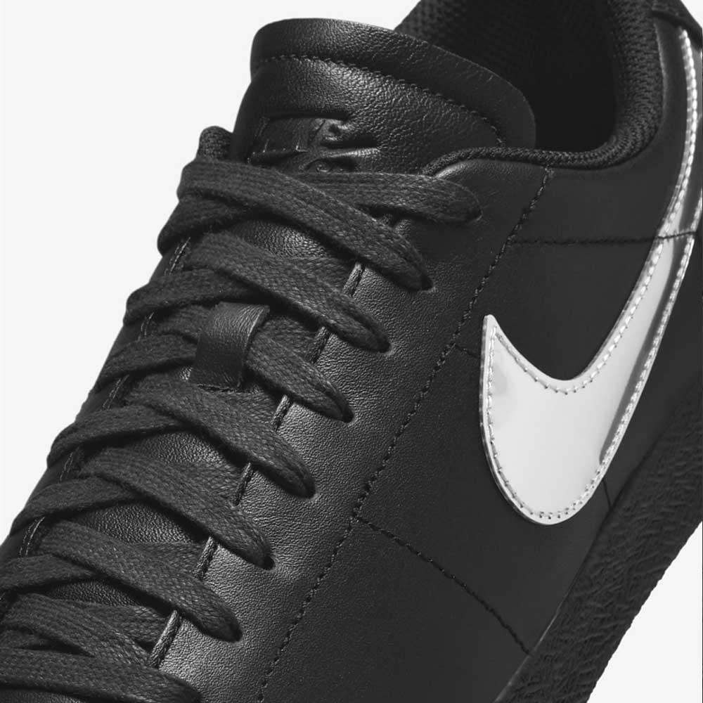 Close-up of the HJ6703001 Black White Silver Blazer Low Dancer Nike SB leather skateboarding shoes, featuring black laces, a white swoosh logo, and highlighted premium texture and stitching details.