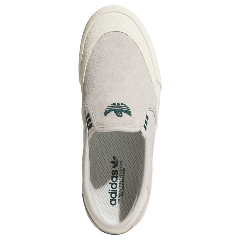 A top view of the HQ4721 Gray White Shmoofoil Slip RX Adidas Skateboarding suede shoe, featuring a light gray upper, cream accents, green tongue branding, and black insole logo—ideal for classic adidas footwear fans.