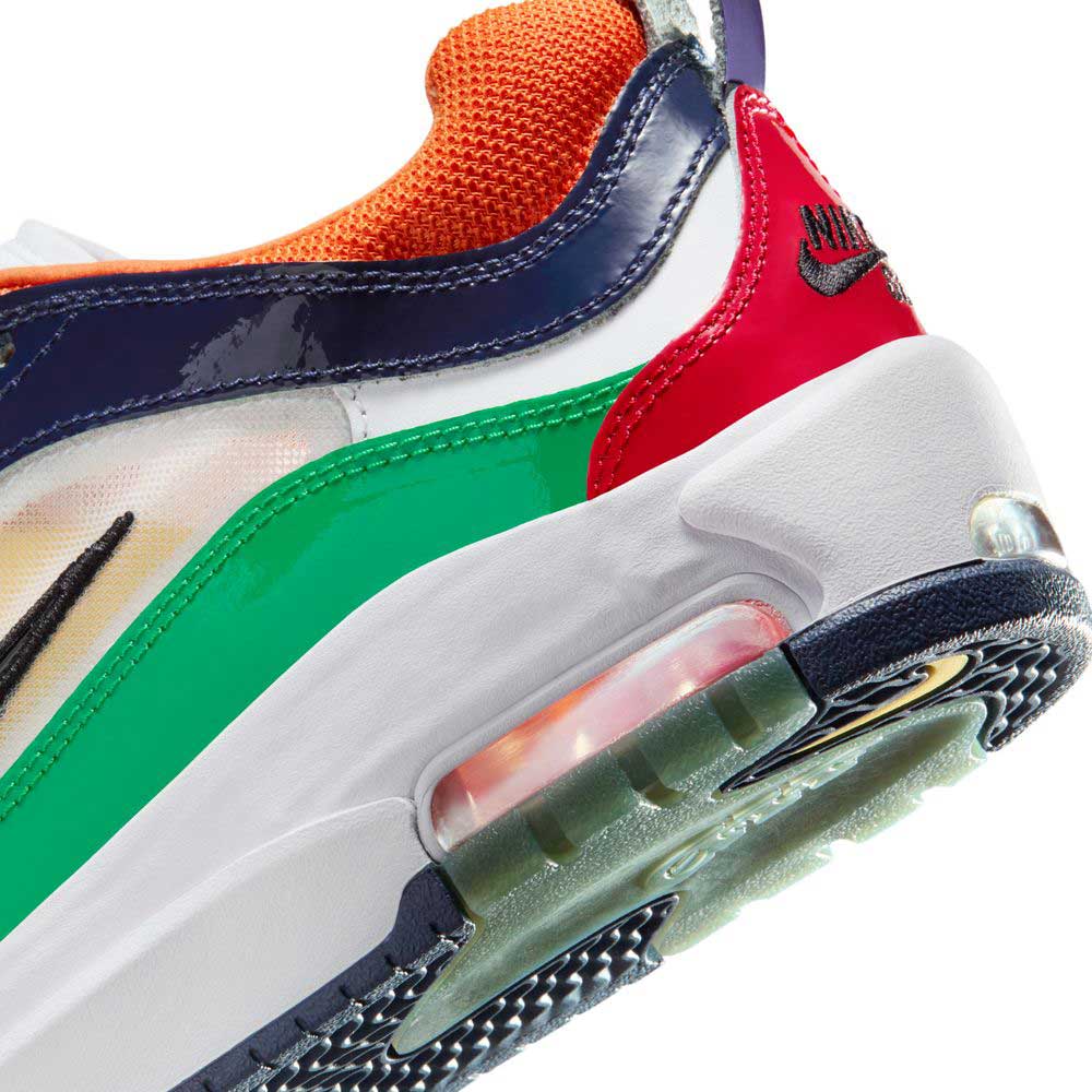 Close-up of the Nike SB Air Max Ishod (HV1670600) in University Red, Black, Amarillo, and Navy, featuring suede and leather panels, visible Max Air cushioning, and a black embroidered Nike logo on the red heel tab.