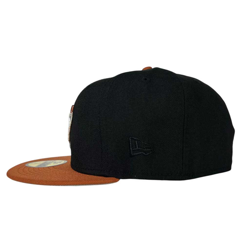 The Harvest Black Space City Houston Astros New Era Hat 5950 Fitted by Whatafitted is shown from the back-left, featuring a flat brown brim, black embroidered Astros logo on the side, and a sticker on the brim.