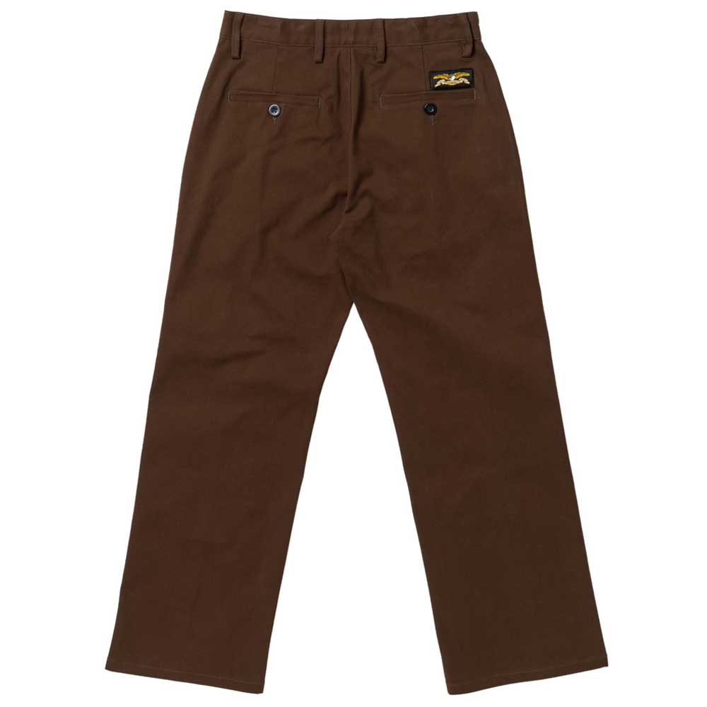 The Hecho Por Skate Pant by Anti Hero Skateboards in brown features two rear buttoned pockets, a small patch above the right pocket, belt loops, and a straight leg cut—ideal for Skateshop Day or limited drops.
