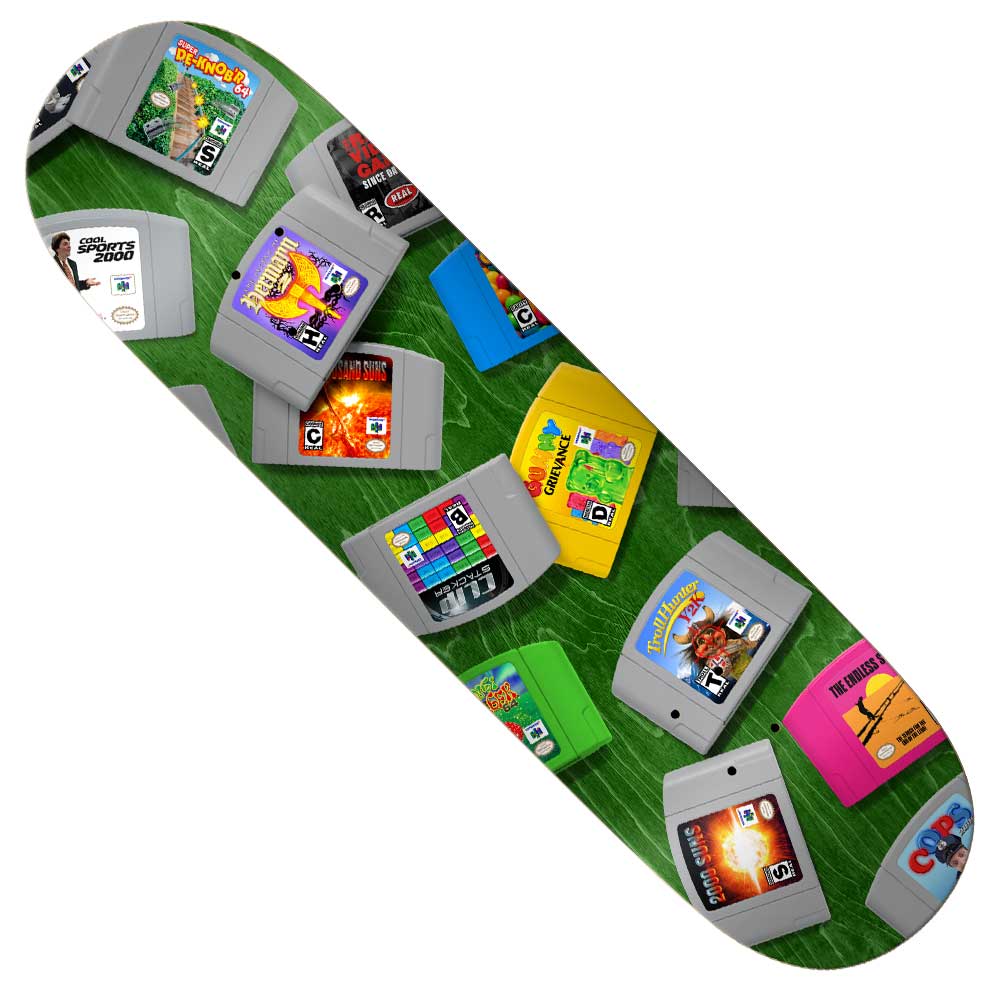 The Herman 64 Bit 8.25 True Fit Real Skateboards Deck features a green background decorated with vibrant, uniquely labeled Nintendo 64 game cartridges and colorful game artwork.