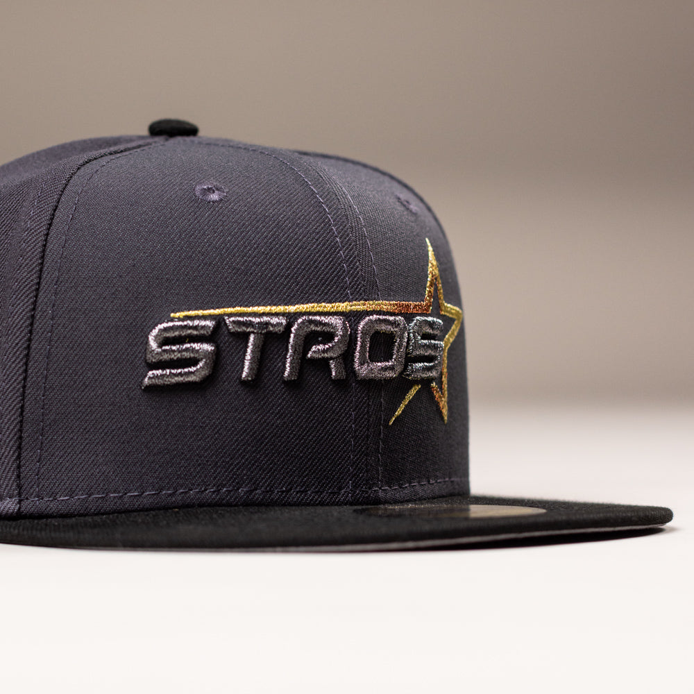 Black Delta City Connect Houston Astros New Era Hat 5950 Fitted dark grey cap with an embroidered STROS logo featuring a metallic gold and orange star.