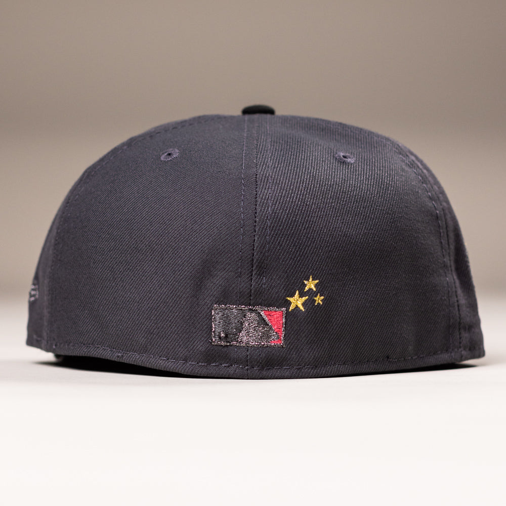 Back view of a black Delta City Connect Houston Astros New Era Hat 5950 Fitted, featuring a Major League Baseball logo with a red panel and two gold embroidered stars.