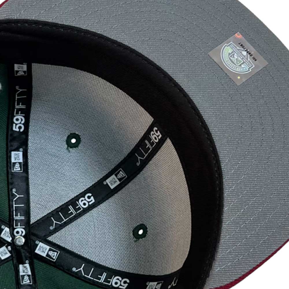 Close-up of the El Sarape Sugar Land Space Cowboys New Era Hat 5950 Day, featuring a gray brim, black inner band with 59FIFTY labels, reflective sticker, and green crown with dark stitching—a stylish Whatafitted cap.