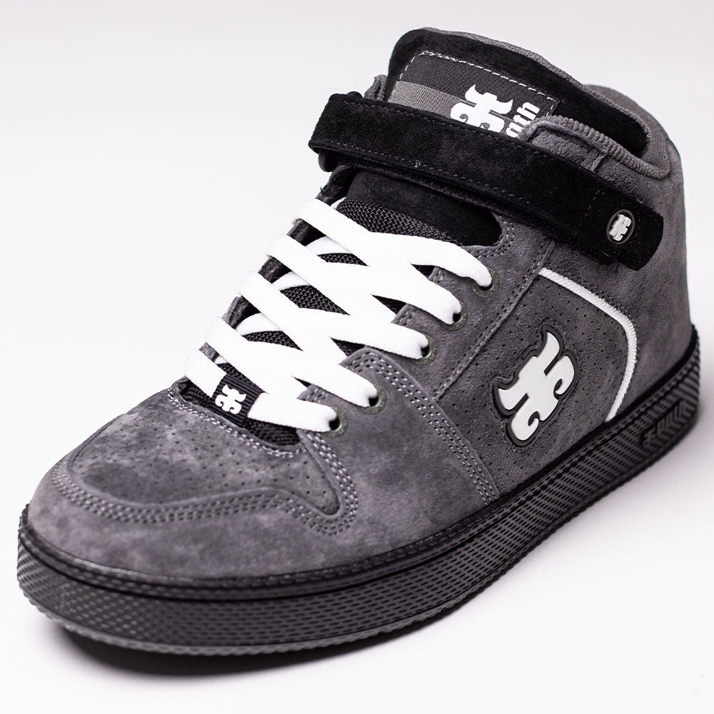 Grasshopper Gray Suede I Path Shoes Skateboarding feature a classic high-top silhouette in premium grey suede, accented with white laces, a black sole, and a distinctive black ankle strap. Showcasing subtle Grasshopper inspiration, these shoes display the iconic puzzle piece logo on the side and tongue, while bold black and white details add standout appeal.