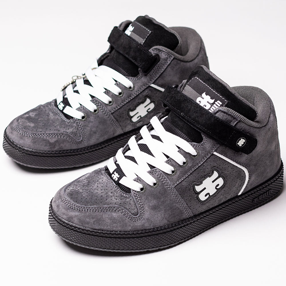 A pair of Grasshopper Gray Suede I Path Shoes for skateboarding, featuring black soles, white laces, and velcro straps. These sneakers display a white puzzle piece logo on the side and tongue, subtle IPATH branding, and are shown against a white background.