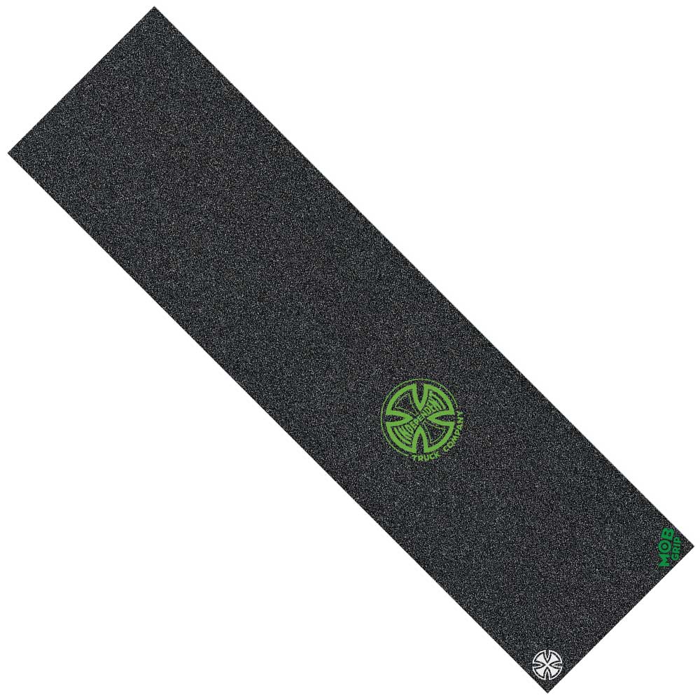 The Independent Legacy Logo OGBC Grip Tape is a rectangular, 9″ x 33″ sheet of black griptape by Graphic Mob, featuring a green circular Independent logo near the center and a small white Mob Grip logo in one corner. The surface has a gritty, sandpaper-like texture similar to the popular Splatter Span design.