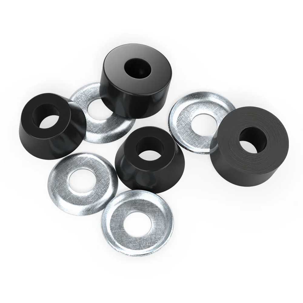 Four Indy Standard Cylinder Cushions Hard 94A Black skateboard bushings and four silver washers are arranged on a white surface. Each high rebound urethane bushing has a central hole, as do the circular metal washers.