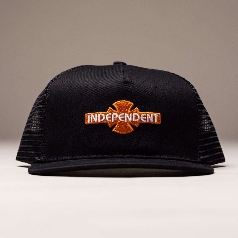 The OGBC Legacy Black Orange Hat Shadow Snapback by Independent Skateboards features a black mesh back, orange cross logo, and INDEPENDENT embroidered on the cotton twill front, shown against a neutral background. Unisex, unstructured OS fit.