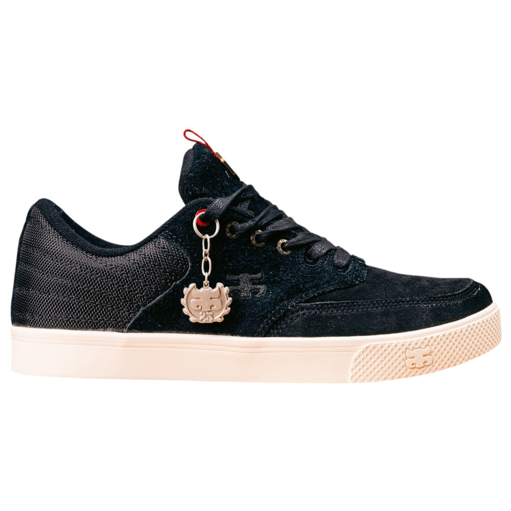 The Poet Black Suede Ballistic Nylon I Path Skateboarding Shoe features a black upper, white sole, black laces, a metal cartoon face charm on the side, durable ballistic nylon with a textured finish, and a small logo near the laces.