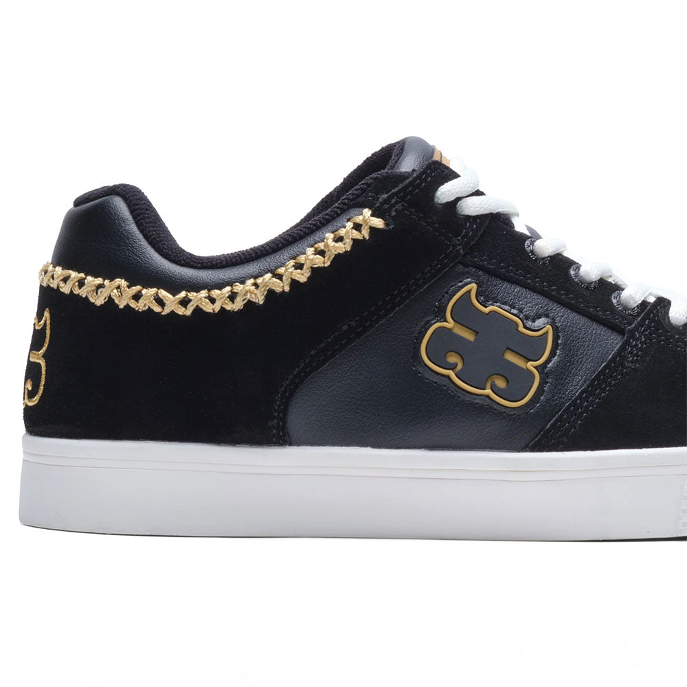 The Kenny Reed Low Vulc Black Leather Suede I Path Skateboarding shoe features black leather, white laces and sole, gold embroidered collar stitching, and a gold side logo.