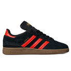 The JH8134 Black Orange Gum Busenitz Adidas Skateboarding Suede Shoes feature black suede, orange stripes and heel accents, gold Busenitz branding, black laces, and a brown gum sole—echoing the Copa Mundial skate shoe design.