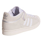 The JH8141 White Silver White Pro Shell Mid Trainers ADV Adidas Suede Skateboarding Shoes feature a light beige, vintage basketball-inspired look, with white stripes, laces, and sole. The back sports a silver Adidas logo and shiny silver accent.