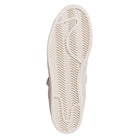 The image shows the sole of the JH8141 White Silver White Pro Shell Mid Trainers ADV Adidas Suede Skateboarding Shoes, featuring a herringbone tread for grip, a slightly curved vintage outline, and a textured surface when viewed from the bottom.