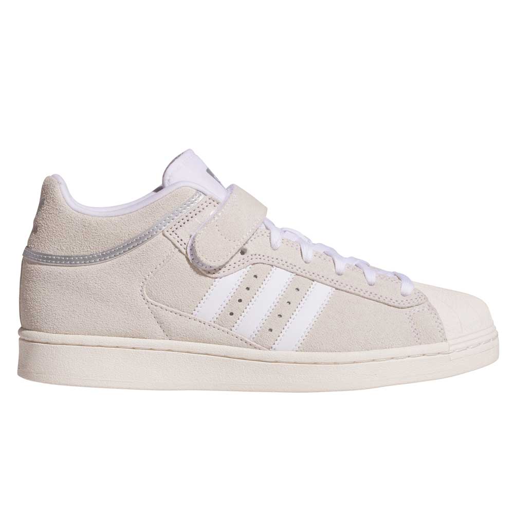 The JH8141 White Silver White Pro Shell Mid Trainers ADV by Adidas feature beige suede uppers, a white rubber sole, white toe cap, white laces, three white side stripes, and a Velcro strap, blending vintage basketball style with skateboarding performance.