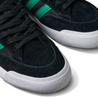 Close-up of JH8143 Nora Black Green Suede Adidas Skateboarding Shoes featuring green stripes, black laces, and white rubber soles, displayed on a white background.
