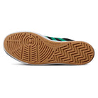 The image displays the sole of the JH8143 Nora Black Green Suede Adidas Skateboarding Shoe, featuring a gum rubber outsole with vintage-inspired circular and zigzag traction patterns. The Adidas logo is visible near the arch.