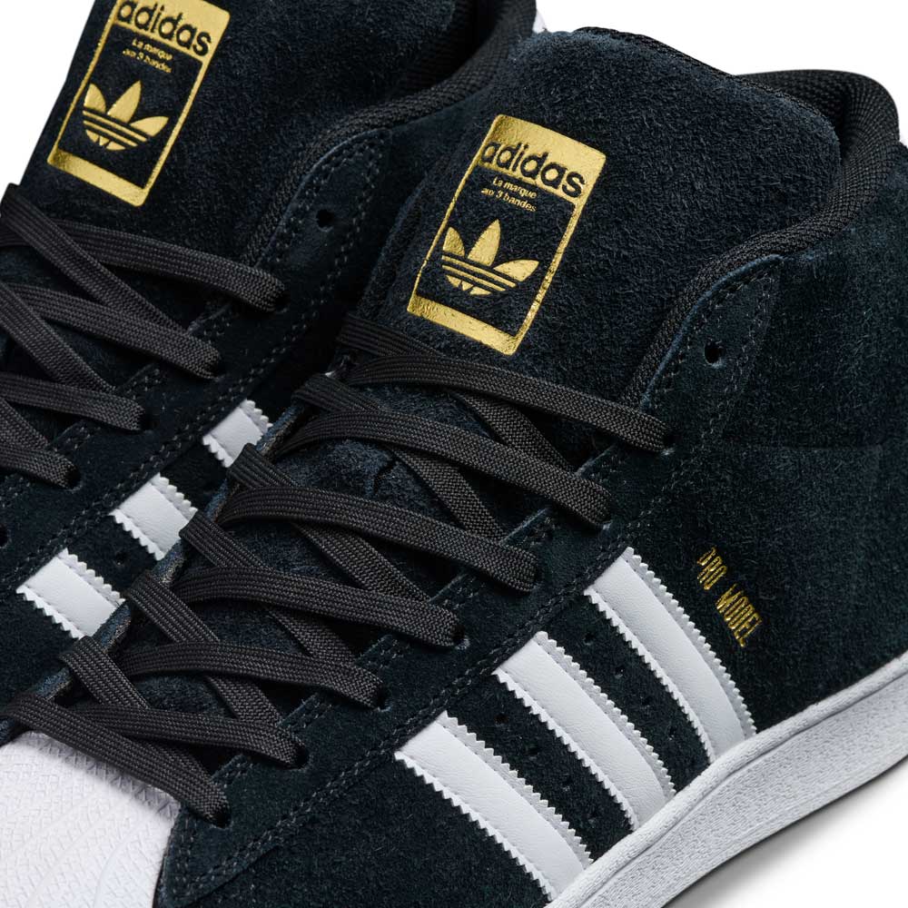 Close-up of JH8146 Black White Gold Suede Pro Model ADV Adidas Skateboarding Shoes featuring black suede, white stripes, black laces, and gold “Adidas” and “244 MODEL” branding on the tongue and side.