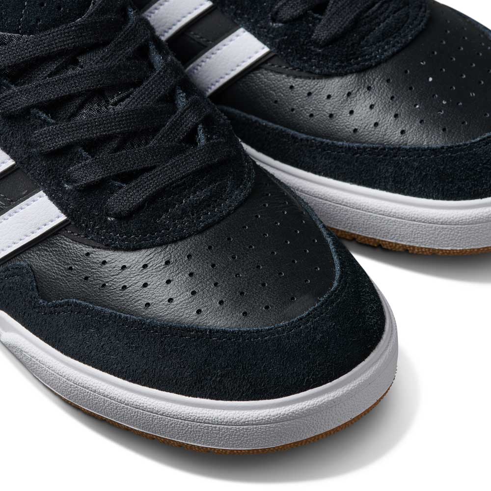 Close-up of the JI 0846 Black White Gum Tyshawn II Adidas Skateboarding Shoes, featuring black leather and suede uppers with white side stripes, perforations, black laces, and classic white soles.