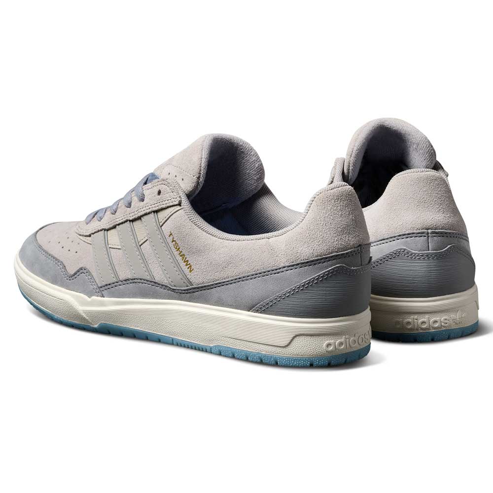 A pair of JI0848 Granite White Tyshawn 2 II Adidas Skateboarding Shoes with leather and suede, blue sole accents, and FORUM in gold on the side, shown from the back and side on a white background.