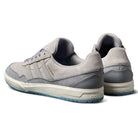 A pair of JI0848 Granite White Tyshawn 2 II Adidas Skateboarding Shoes with leather and suede, blue sole accents, and FORUM in gold on the side, shown from the back and side on a white background.