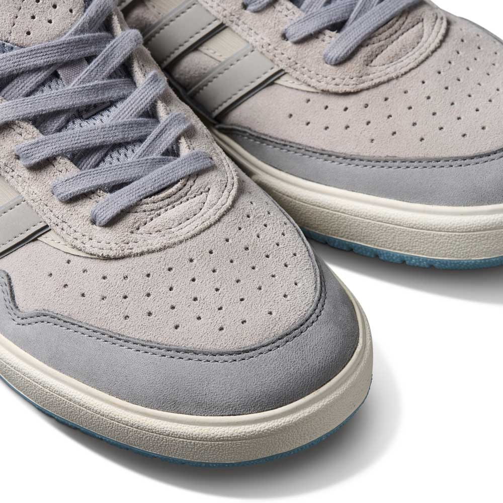 Close-up of two JI0848 Granite White Tyshawn 2 II Adidas Skateboarding Leather Suede Shoes, featuring perforated toes, gray laces, white midsoles, and subtle side stripes, displayed on a white background.