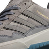 Close-up of the JI0848 Granite White Tyshawn 2 Adidas Skateboarding Shoe, featuring grey suede, three grey stripes, a blue-tinted outsole, and "TYSHAWN" gold lettering on the side.