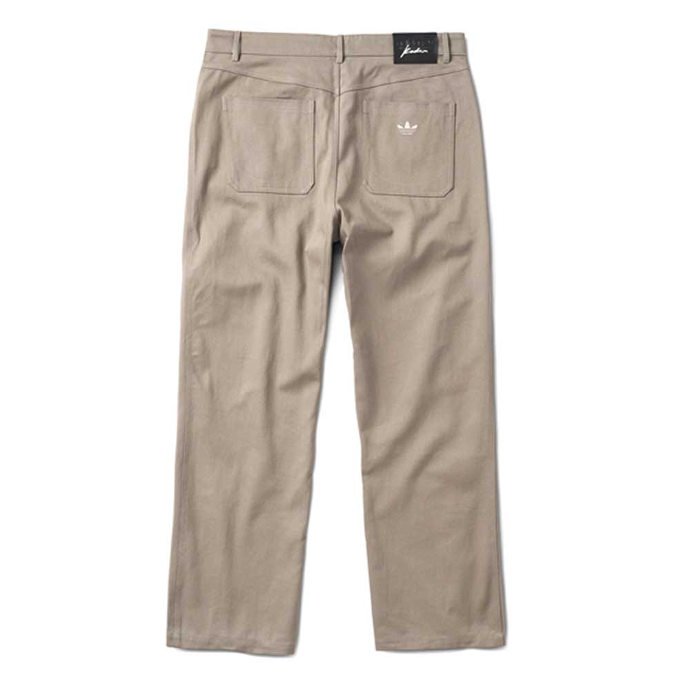 JM5832 Gray Clay Kader Sylla Pant by Adidas shown from the back, features a straight-leg fit, two rear pockets (one with an embroidered Adidas trefoil logo), and a black label on the waistband.