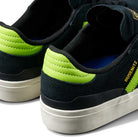 Close-up of the JP5655 Black Neon Green Busenitz Vulc Suede Adidas Skateboarding Shoes, highlighting their black suede, bright green heel accents, white midsoles, and "BUSENITZ" in gold lettering on the side.