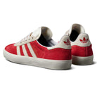 A pair of JP5861 Red White Gold Gazelle ADV Adidas Skateboarding suede shoes featuring white soles, three white side stripes, and the Adidas logo on the heel tab.