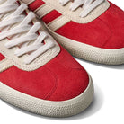 A pair of JP5861 Red White Gold Gazelle ADV Adidas Skateboarding suede shoes.