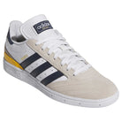 The JP8604 Brown Navy Busenitz Adidas Skateboarding Suede Shoes feature a suede upper, navy stripes, yellow heel detail, white laces, textured sole, and gold "Busenitz" branding—showcasing the iconic Busenitz ADV design.