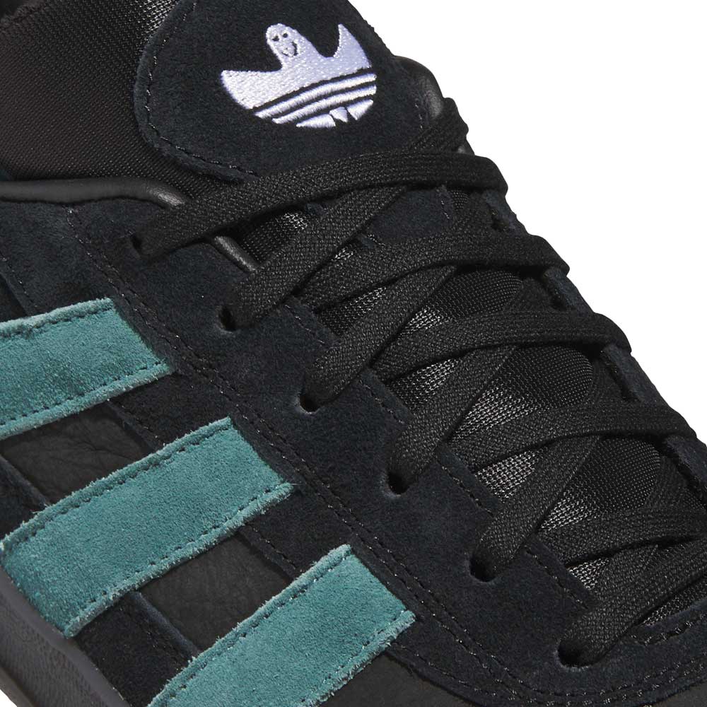 Close-up of the JQ1042 Black Prete Aloha Super Suede Leather Skateboarding Shoes, featuring teal suede stripes, black laces, and a white Adidas logo on the tongue—crafted for superior board control.
