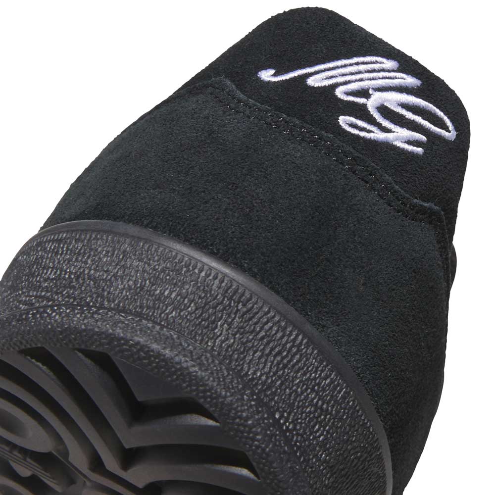 Close-up of the JQ1042 Black Prete Aloha Super Suede Leather Skateboarding Shoe's heel, highlighting its textured black rubber sole and white MG initials on the upper back for style and control.
