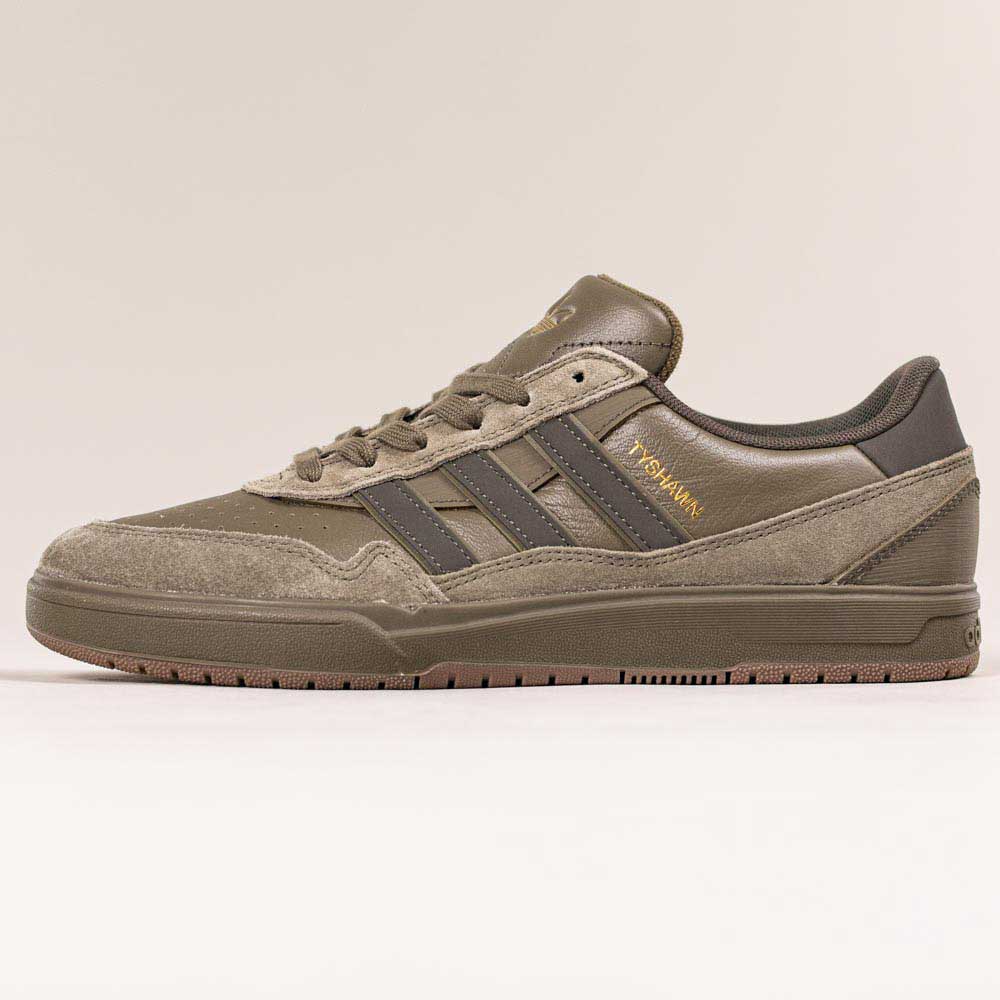 A side view of the JQ1132 Olive Strata Shadow Olive Tyshawn 2 II Adidas Skateboarding Shoes, featuring suede and premium leather panels, three dark green stripes, a Lightstrike midsole, and KASINA in gold on the side, against a plain background.
