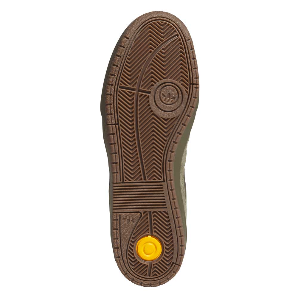 A brown rubber sole with intricate tread patterns, a circular logo at the center, and a small yellow detail near the heel, inspired by the JQ1132 Olive Strata Shadow Olive Tyshawn 2 II Adidas Skateboarding Shoes.