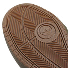 Close-up of the brown rubber sole of the JQ1132 Olive Strata Shadow Olive Tyshawn 2 II Adidas Skateboarding Shoes, showing a circular trefoil logo, detailed herringbone tread for grip, and Lightstrike midsole cushioning for comfort.