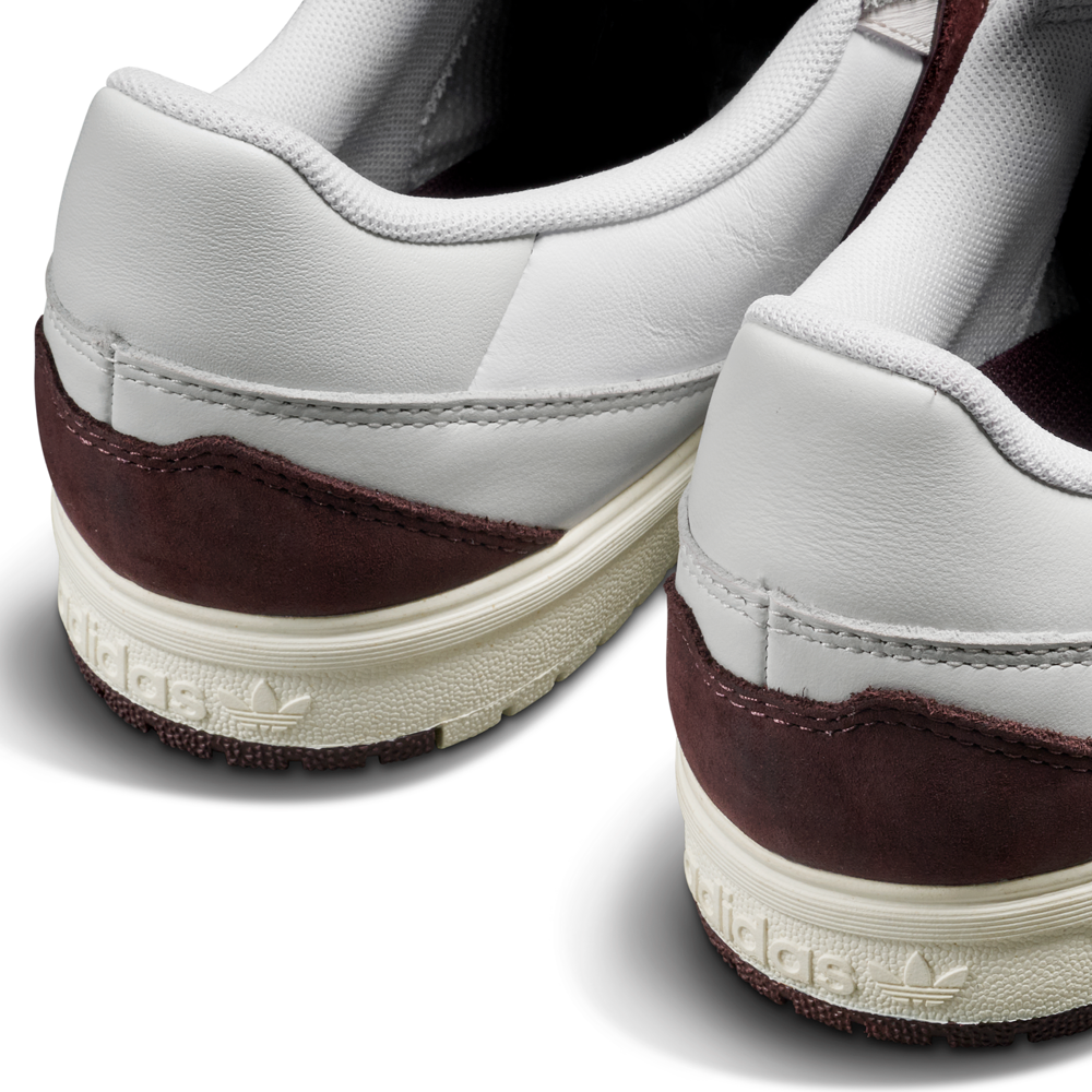 Close-up of the JQ1620 Crystal White Brown Zach Saraceno Tyshawn 2 II Adidas Skateboarding Shoes, showing premium white leather uppers, maroon suede accents, cream Lightstrike midsoles, and embossed Adidas heel logo.