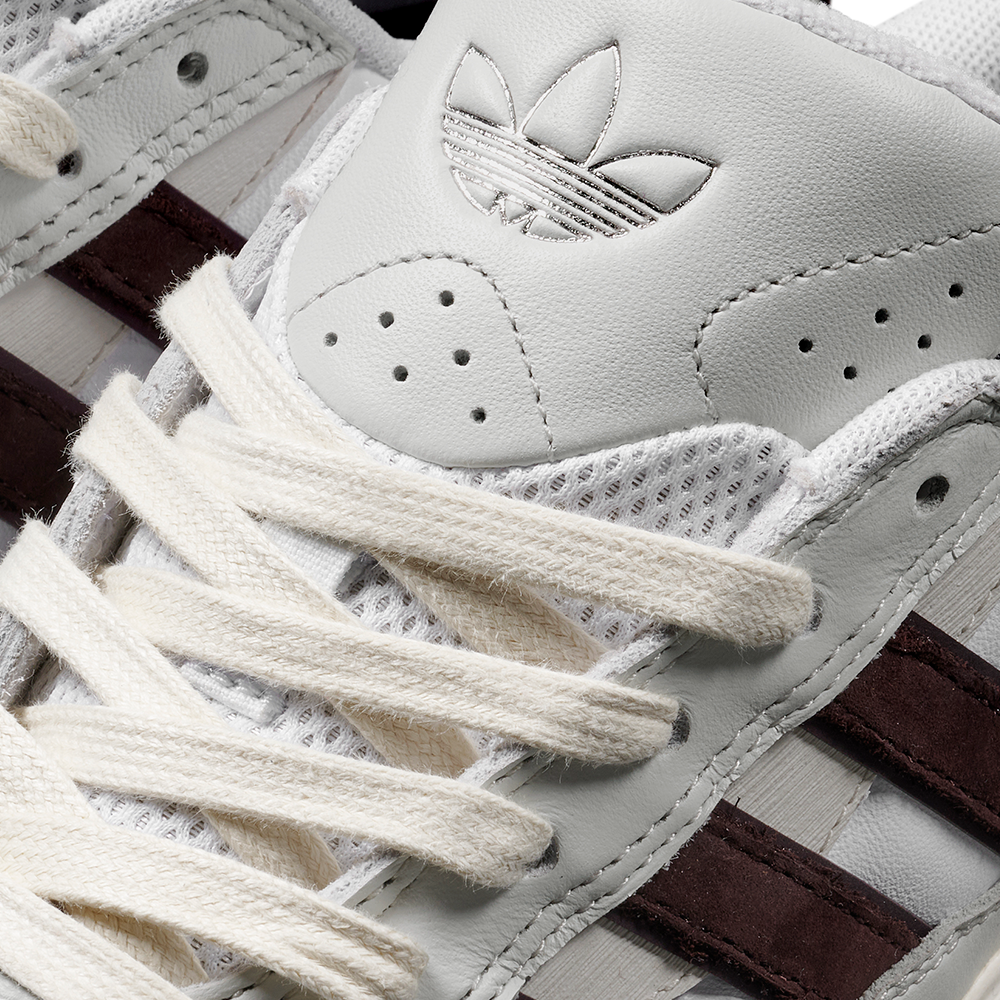 Close-up of the JQ1620 Crystal White Brown Zach Saraceno Tyshawn 2 II Adidas Skateboarding Shoes, featuring cream laces, a leather tongue with trefoil logo, maroon side stripes, and a Lightstrike midsole for premium comfort.