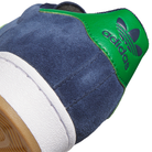 Close-up of the heel on the JQ2098 Navy Green White Superstar ADV Adidas Suede Skateboarding Shoes, showing blue suede, green leather with trefoil logo, durable cupsole, white midsole, and brown rubber outsole.