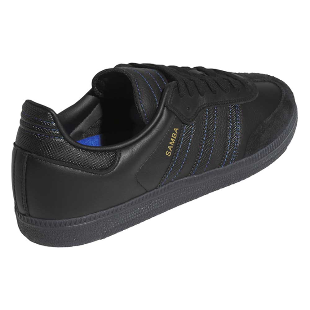 The JR2059 Black Black Samba ADV Adidas Skateboarding shoes feature leather and suede, blue accents, gold SAMBA lettering, a molded sockliner, and a textured black sole, shown at an angle from the back and side.