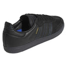 The JR2059 Black Black Samba ADV Adidas Skateboarding shoes feature leather and suede, blue accents, gold SAMBA lettering, a molded sockliner, and a textured black sole, shown at an angle from the back and side.