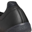 Close-up of the back heel of the JR2059 Black Black Samba ADV Adidas Skateboarding Leather Suede Shoes, showing textured leather, stitched seam, part of a patterned rubber sole, and blue top stitching.