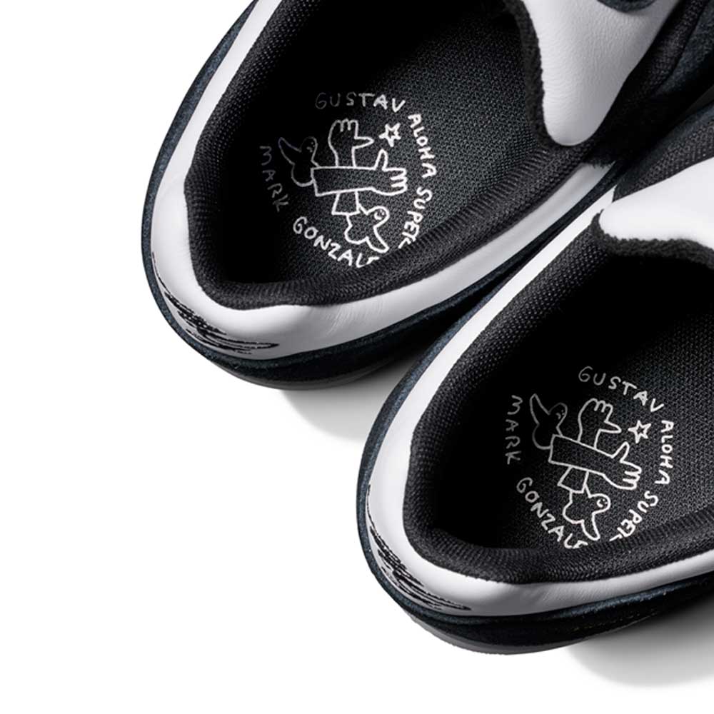 Close-up of the insoles on the JR7101 Gustav Tonnesen Black White Aloha Super Suede Leather Skateboarding Shoes, showing a doodle-style figure and the words GUSTAV, Aloha Super, and MARK GONZALES in white on black inner soles.