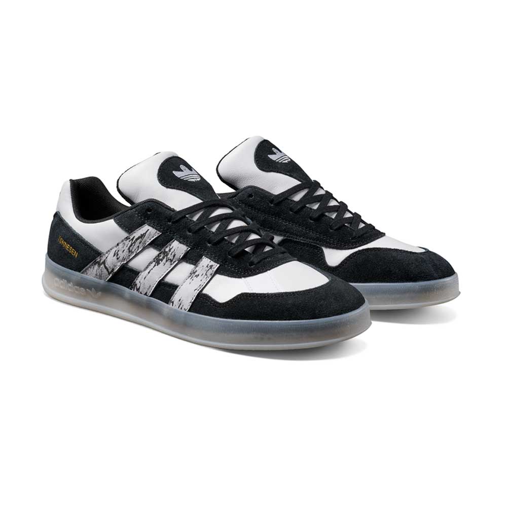 The JR7101 Gustav Tonnesen Black White Aloha Super Suede Leather Skateboarding Shoes feature black suede overlays, white leather panels, black laces, distressed three white stripes, a translucent rubber sole, and an Adidas logo on the tongue.