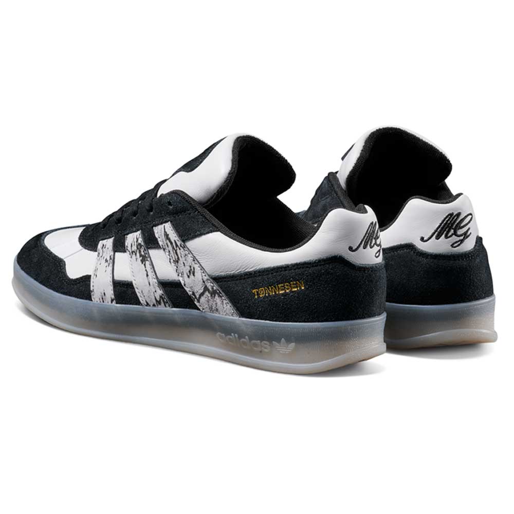 The JR7101 Gustav Tonnesen Black White Aloha Super Suede Leather Skateboarding Shoes feature a translucent sole, brushstroke stripes, and MG/TOWNSED heel and side text—perfect for skateboarding, inspired by Gustav Tonnesen.